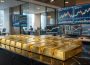 Lingotes de ouro e ecrãs de mercados